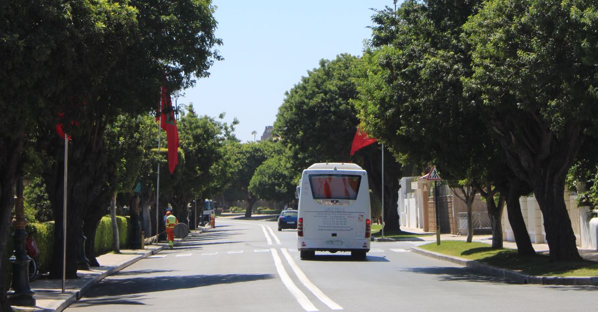 Des techniciens marocains assemblant des composants électriques sur un châssis de bus.